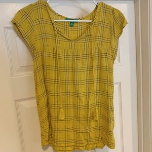 Yellow shirt with black stripes and fun tassels in the front